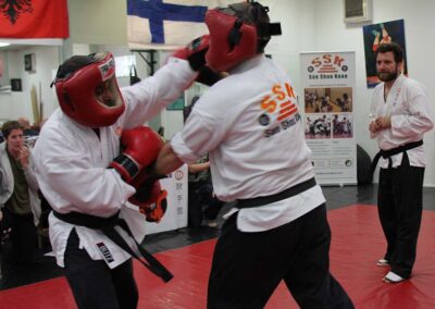 Free sparring an opponent from previous Black Belt grading to maintain consistency of standards between Black Belt gradings